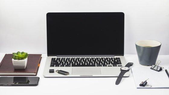 lifestyle hacks to increase productivity - clean work station - a cup of coffee, wrist watch, flash drive, smartphone