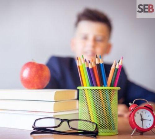back to school marketing ideas - stacks of books with apple on top, eyeglasses, alarm clock and bunch of pencils